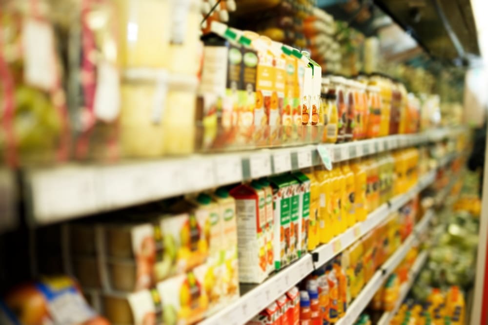 Blurry shelves of colorful products in Sunset grocery and dairy department